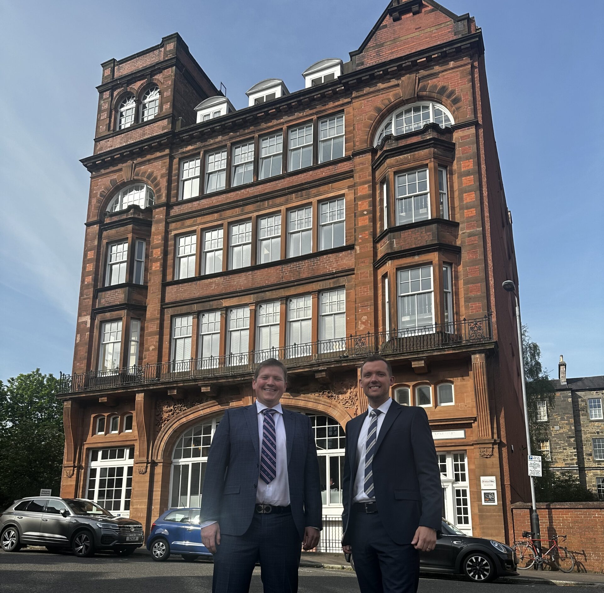 Greg and David standing outside Allied Surveyors Scotland’s head office, Herbert House